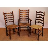 A set of six stained beech ladder back chairs, with rush seats on tapered legs,