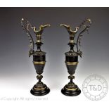 A pair of 19th century Renaissance revival bronze and gilt metal ewers,