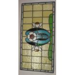 An Edwardian stained lead glass window pane, decorated with a central flower,