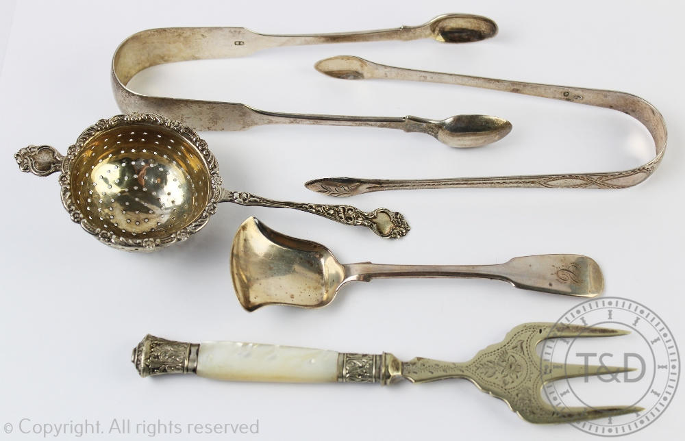 A selection of silver to include; a silver tea strainer Charles Wilkes Birmingham 1914,