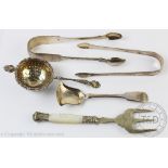 A selection of silver to include; a silver tea strainer Charles Wilkes Birmingham 1914,