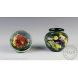 A Moorcroft Hibiscus pattern vase, against a graded green ground, label to underside, 7.