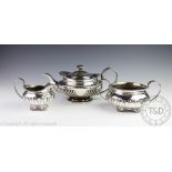 An assembled three piece silver tea service, each piece of low rounded form, with fluted detail,