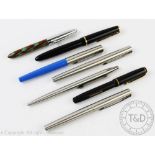 A collection of Parker fountain pens including a Parker Junior with 14k nib, a Parker IE and IIE,
