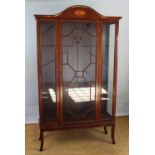 An Edwardian style inlaid mahogany display cabinet, with glazed door enclosing glass shelves,