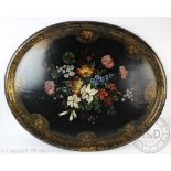 A Victorian lacquered papier-mâché tray, decorated with a spray of flowers, 75.