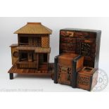 A Japanese wood and bamboo model of a house, on stand with 'stilts', 33cm high,