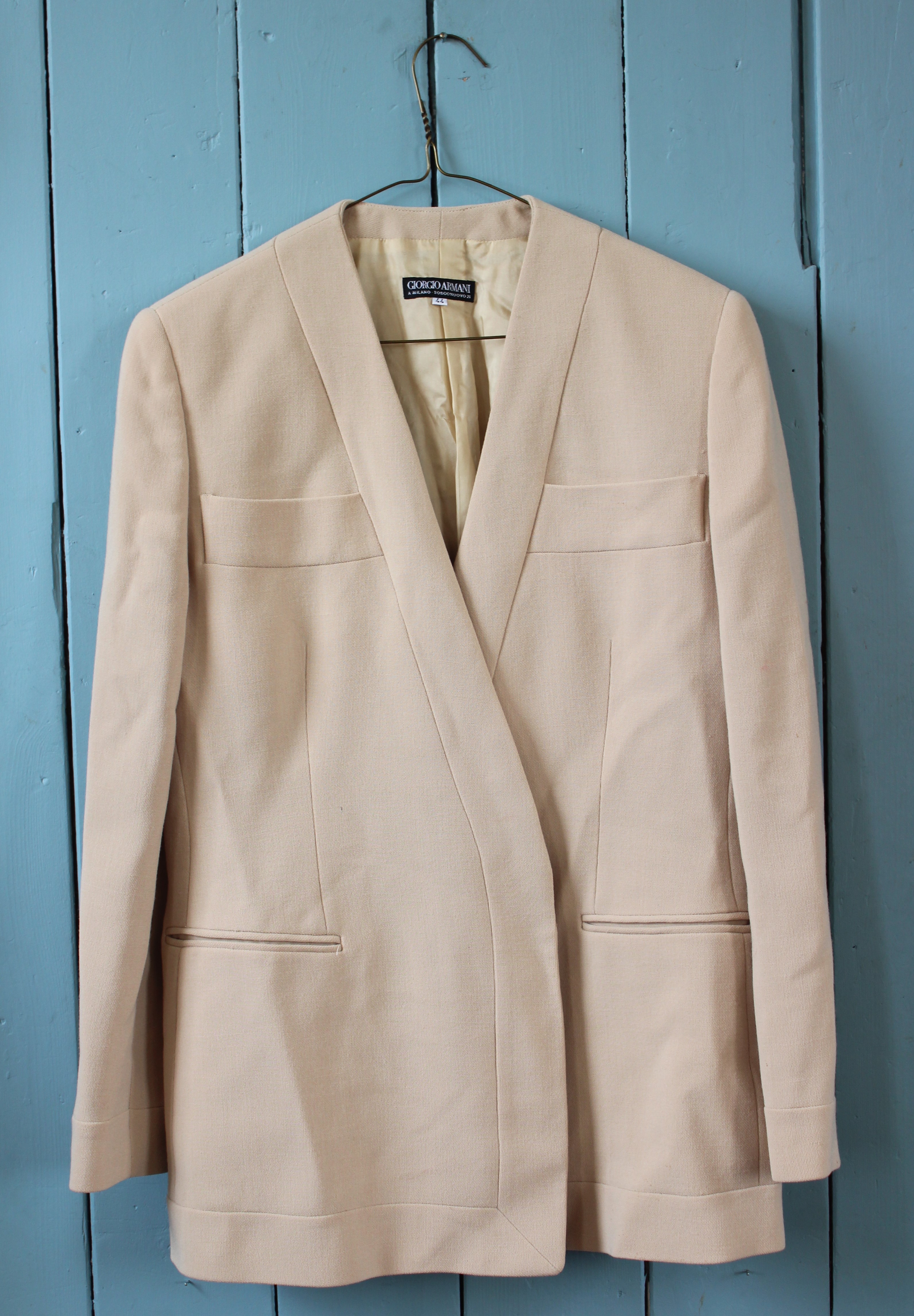 A collection of ladies fashion garments to include a two Giorgio Armani jackets in peach and ivory,