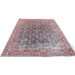 A Persian Mahal hand woven wool carpet, worked with an all over floral design against a blue ground,