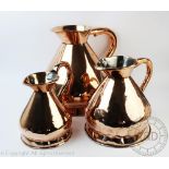 Three graduated copper wine measures, 2 gallon, one gallon and half gallon,