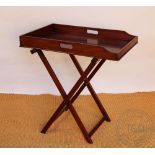 A George III mahogany butlers tray, on folding stand,