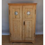 A vintage style pine food hutch / cabinet, with two doors enclosing shelves, on bracket feet,