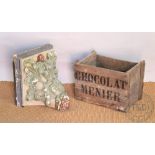 A vintage French 'Chocolat Menier' wood crate/box, 32cm high, with a painted plaster bracket/corbal,