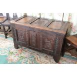 A late 17th century style oak coffer, with carved detailing, on stile feet,
