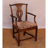 A George III oak country kitchen arm chair, with pierced splat and solid seat, on chamfered legs,