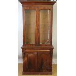 A Victorian mahogany bookcase cabinet, with two glazed doors enclosing shelves,