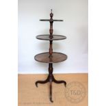 A George III mahogany three tier dumb waiter, with turned finial above three graduated tiers,