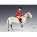 A Beswick huntsman on dapple grey hunter,