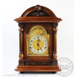 A late Victorian carved walnut eight day mantel clock,