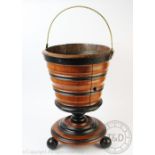 A late 19th century Dutch walnut peat / coal bucket, with turned detailing, on three ball feet,