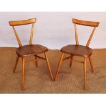 A pair of Ercol beech chairs, with solid seats, on turned legs,