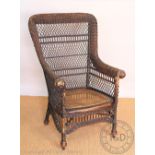 A late 19th / early 20th century woven garden chair - possibly American, with caned seat,