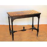 A Victorian carved and ebonised parquetry games table, with back gammon and chess board top,