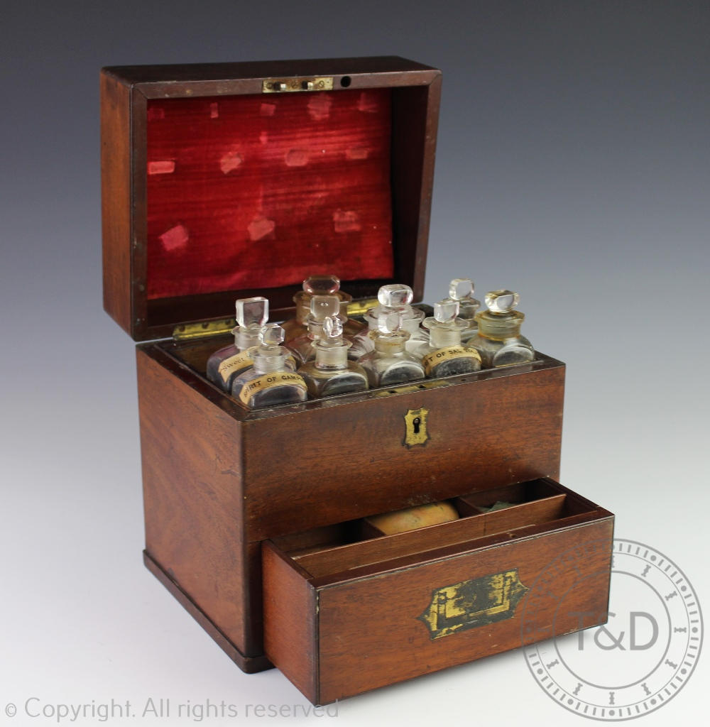 An early 19th century mahogany apothecary cabinet, with recessed brass handles,