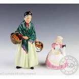A Royal Doulton figure titled 'The Orange Lady', 22cm high and 'Cookie',