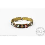 A micro mosaic bracelet, designed as five panels of floral motifs in gilt metal,
