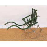 An early 20th century vintage green painted dolls buggy / trap, 66cm high,