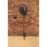 A large wrought iron weather vane surmounted by a cockerel,