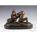 A John Koch bronze of a nude, in an erotic pose, on oval base, signed,