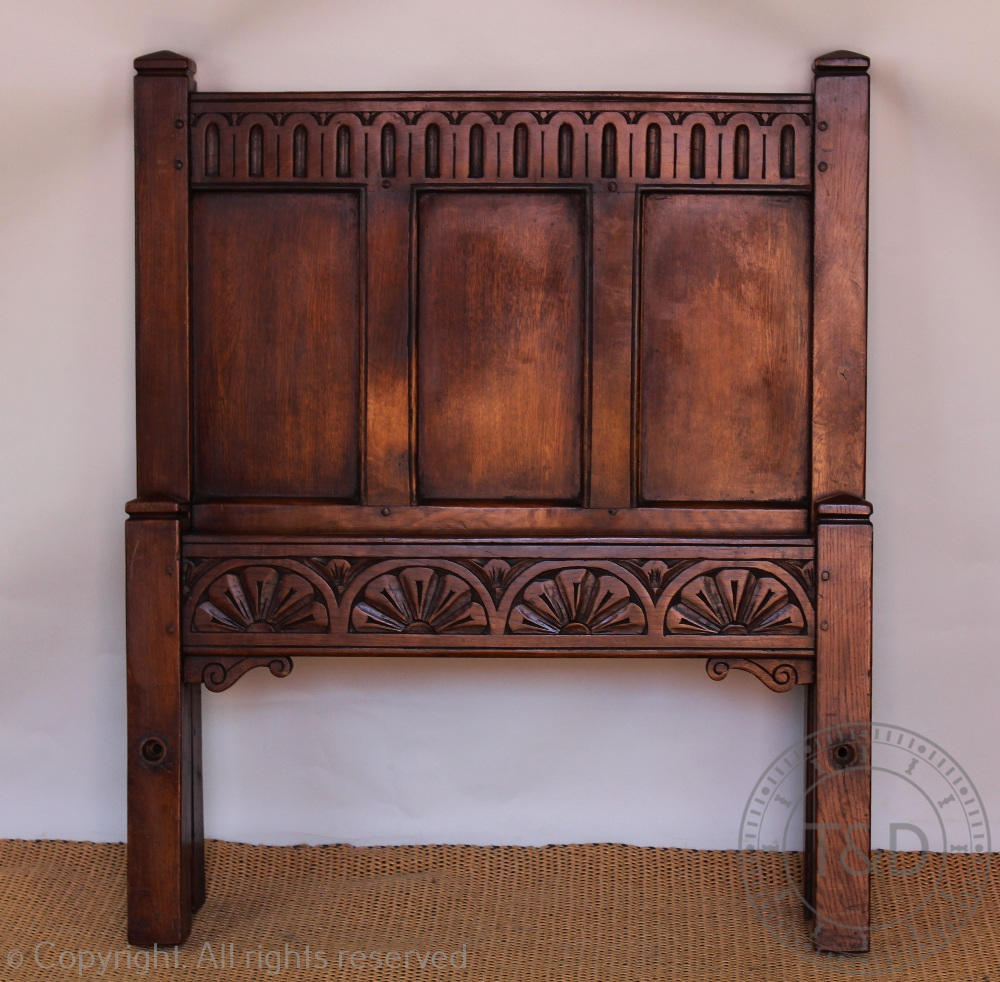 A pair of Child's oak single beds, with panelled head and foot boards, on stile legs,