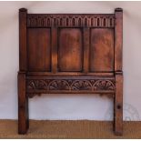 A pair of Child's oak single beds, with panelled head and foot boards, on stile legs,