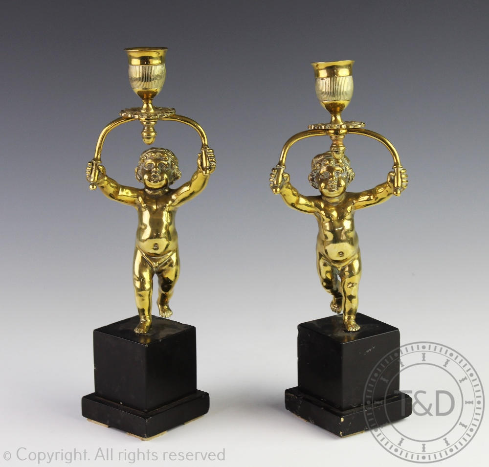 A pair of 19th century figural candlesticks,