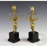 A pair of 19th century figural candlesticks,