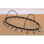 A French wrought iron hanging saucepan rack, oval with twenty hooks,