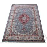 A Kashmir carpet, worked with a medallion and all over floral design against a duck egg blue ground,