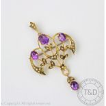 An Edwardian amethyst and seed pearl set brooch/pendant,
