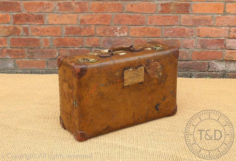 A vintage leather suitcase 'Orient Make', early 20th century, with travel labels,