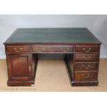 An Edwardian stained partners desk, the top with an arrangement of six drawers,