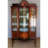An Edwardian inlaid mahogany bow front display cabinet, with door enclosing two shelves,