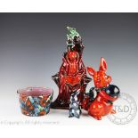 Anita Harris; four pieces of glazed studio pottery comprising; a seated scholar, 34cm high,