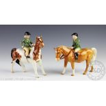 A Beswick Skewbald and Palomino pony, each mounted with a boy and a girl, model No.1500 and No.
