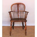 A 19th century ash and elm Windsor type chair, with hoop back and solid seat, on turned legs,