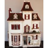 An American style white painted dolls house, accessed from the back, with nine rooms,