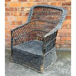 An Edwardian vintage wicker garden chair, with shaped back,