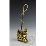 A 19th century cast brass hunting interest door stop, modelled with a foxes mask and whip,