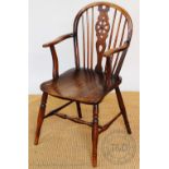 A 19th century ash and elm Windsor type wheel back chair, with saddle seat, on turned legs,